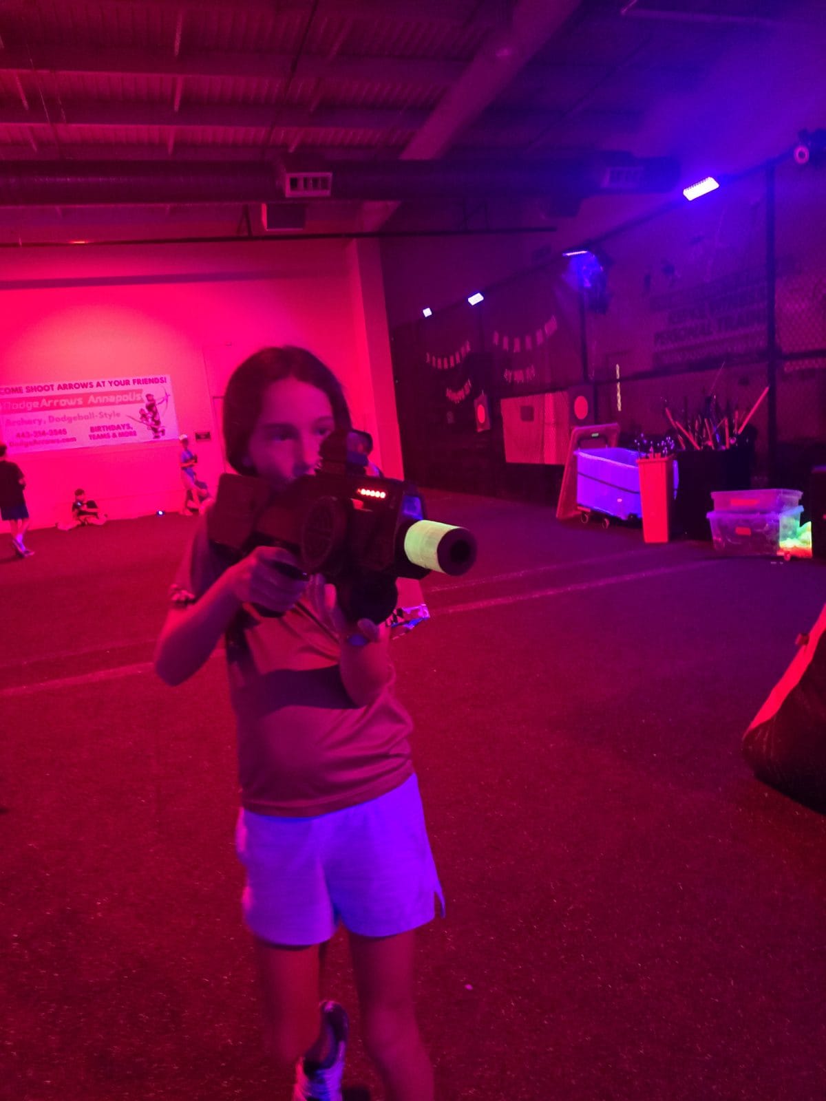 Glow mini golf lane edged with LED strip lighting and a glowing golf ball